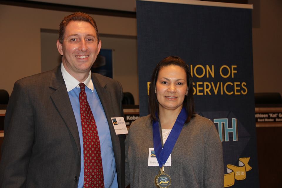 Mireya Hernandez accepts Successful 75 Award from DBS administrator Jeff Whitehead.